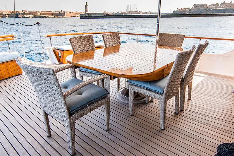 a table and chairs on a deck aboard A&A Yacht for Charter