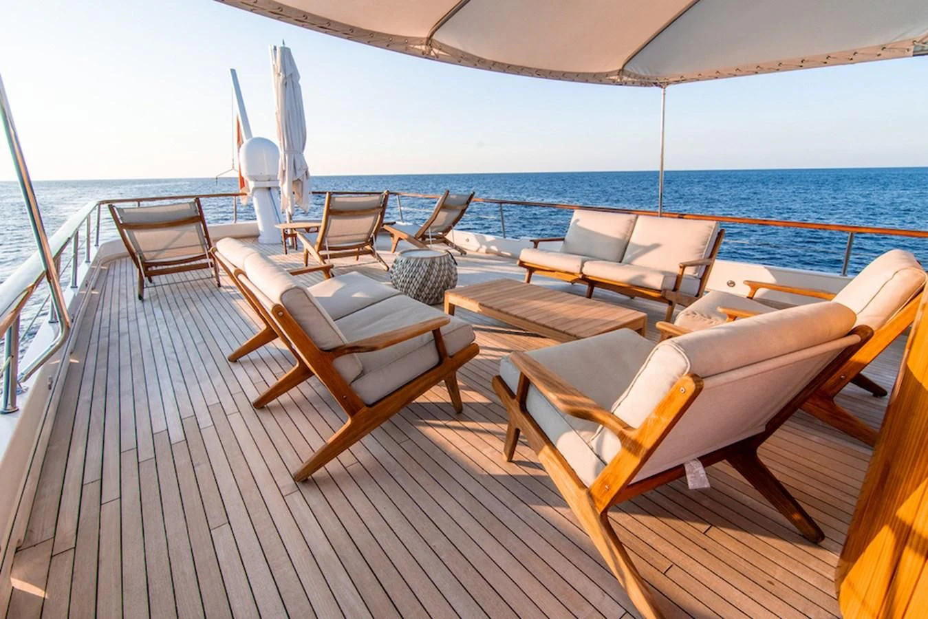 a deck with chairs and a body of water aboard A&A Yacht for Charter