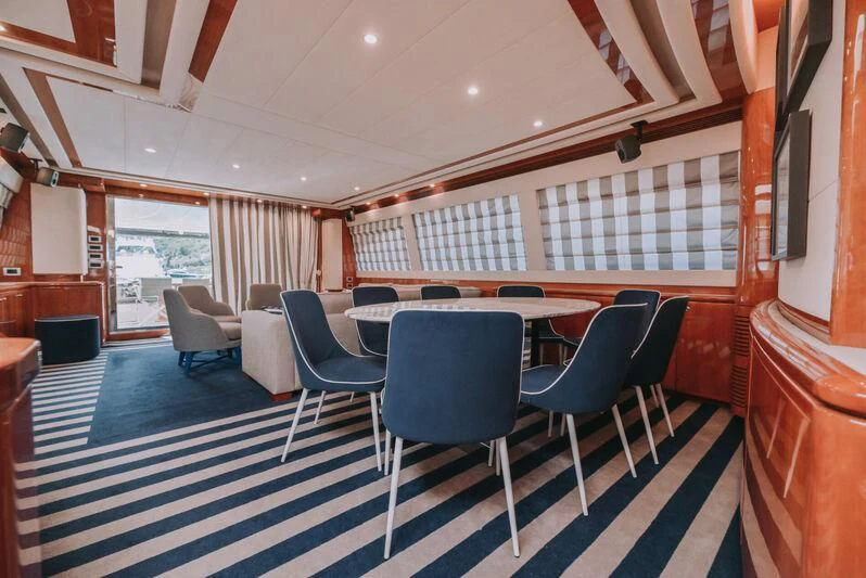 a room with a table chairs and a window aboard SEA YOU Yacht for Sale