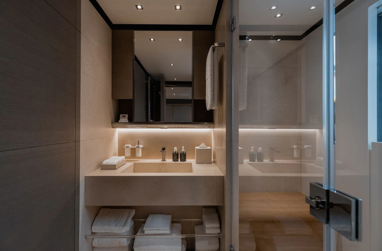 a bathroom with a glass shower aboard LEMON TREE Yacht for Charter