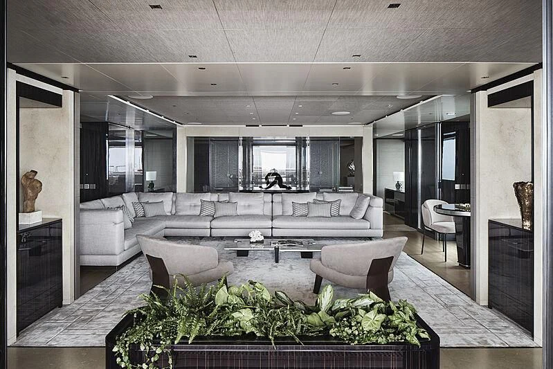 a living room with a large white sofa and a large table aboard LEMON TREE Yacht for Charter