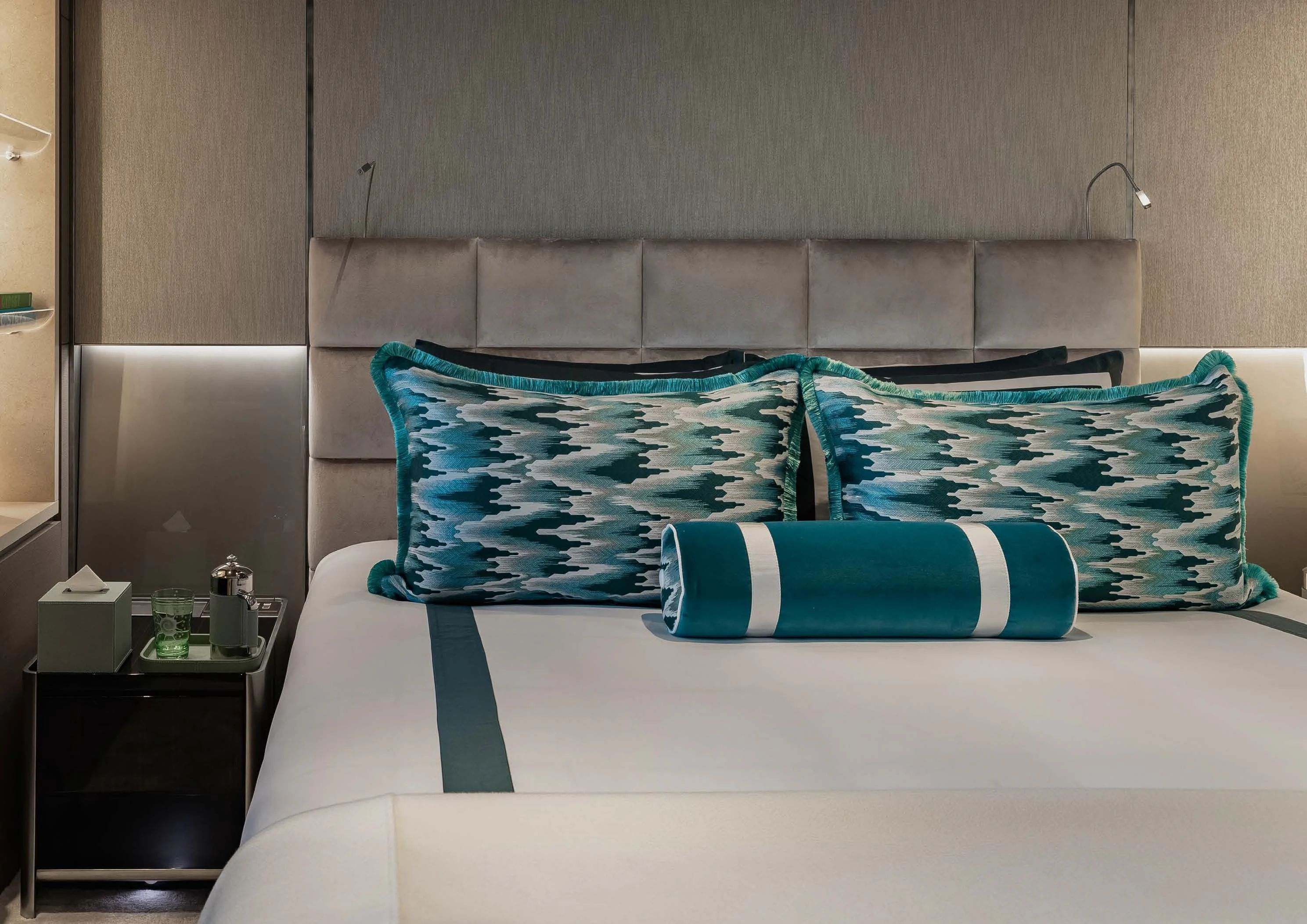 a bed with a blue and white pillow aboard LEMON TREE Yacht for Charter