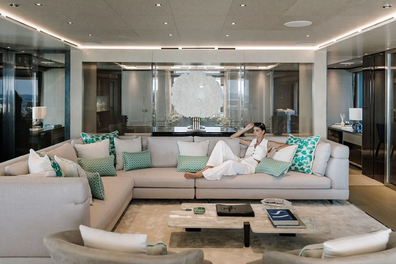 a couple of people sitting on a couch in a large room aboard LEMON TREE Yacht for Charter