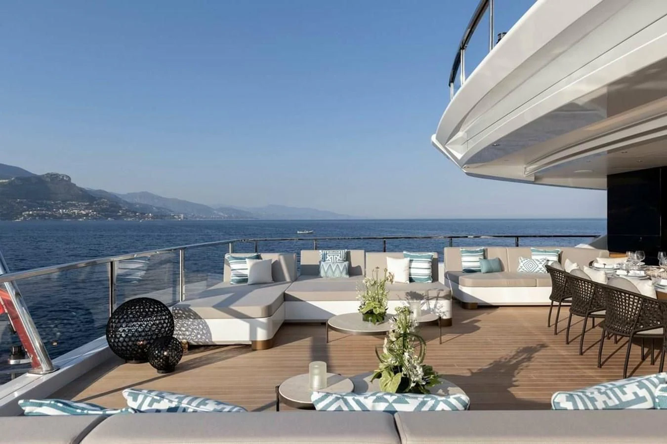 a patio with a table and chairs on it by the water aboard LEMON TREE Yacht for Charter