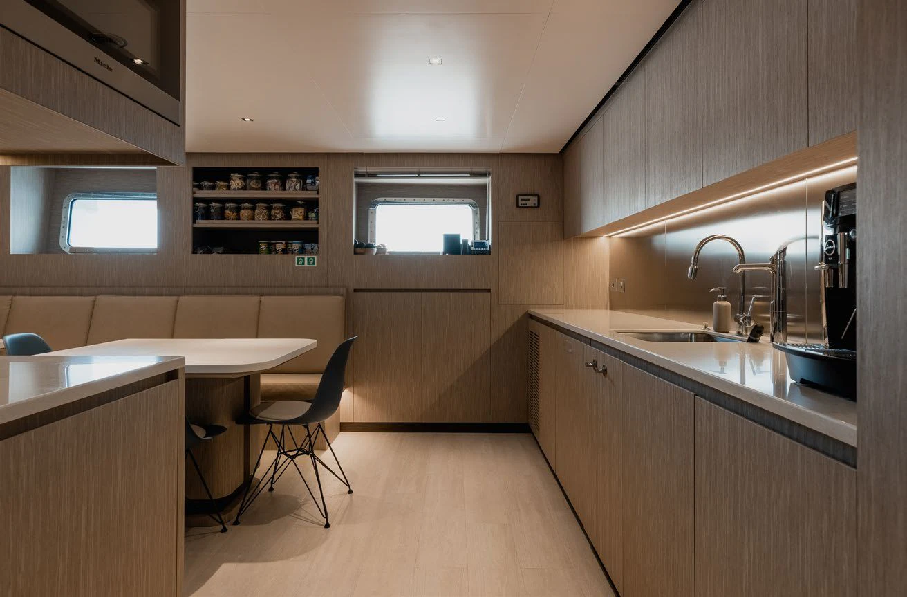 a kitchen with a table and chairs aboard LEMON TREE Yacht for Charter