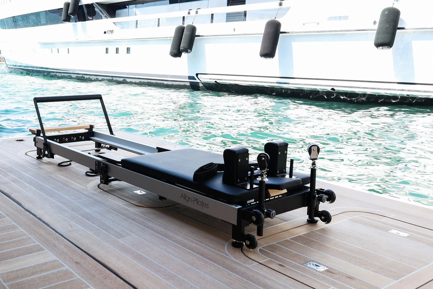 a black and white machine on a deck by a pool aboard LEMON TREE Yacht for Charter