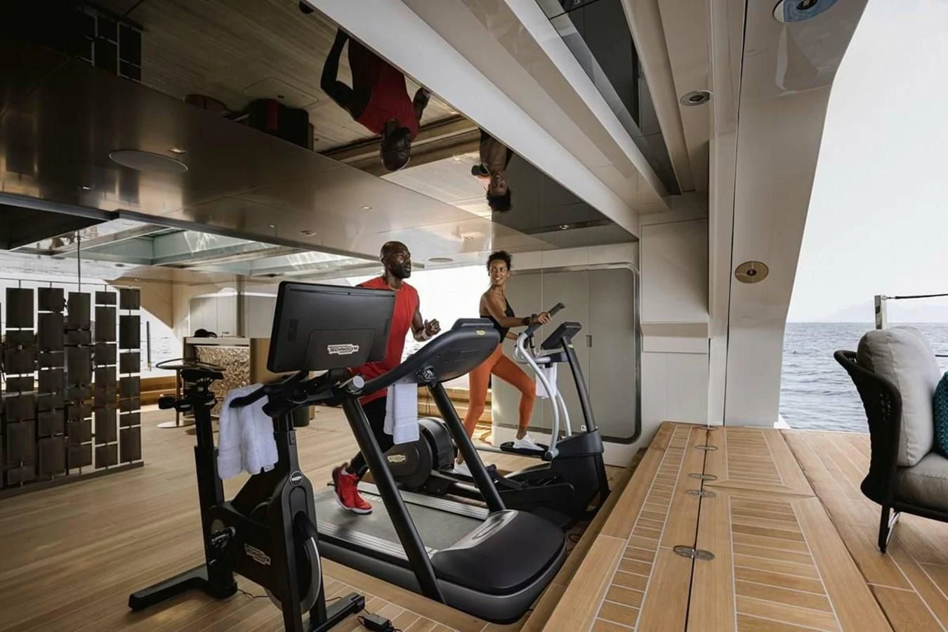 a couple of people working out in a gym aboard LEMON TREE Yacht for Charter