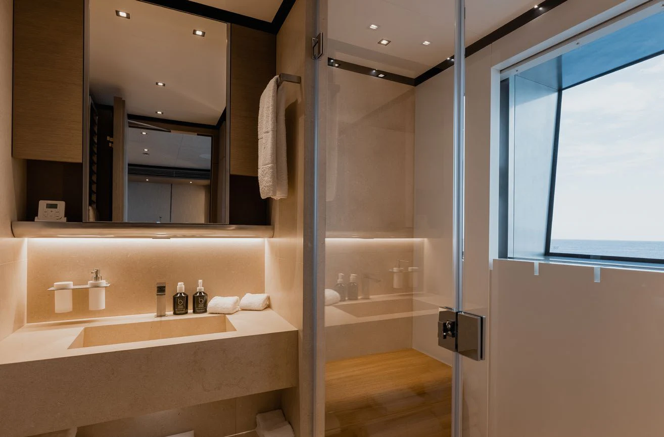 a bathroom with a large mirror aboard LEMON TREE Yacht for Charter