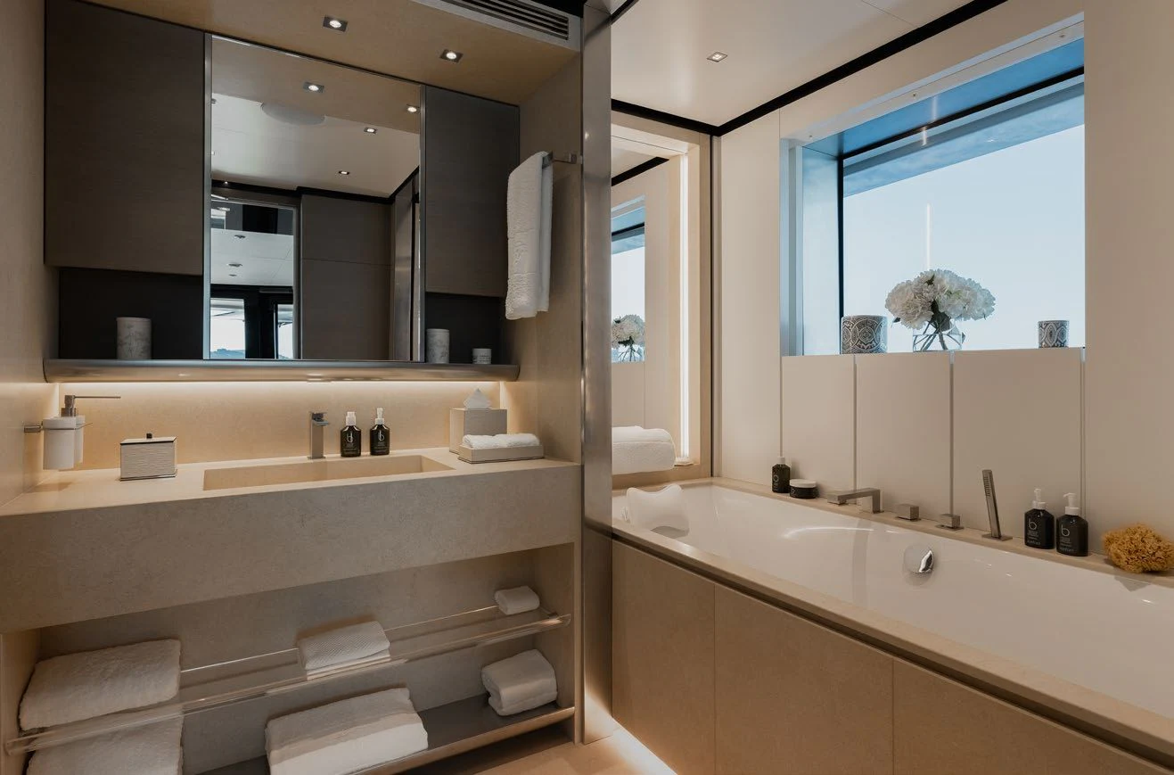 a bathroom with a large mirror aboard LEMON TREE Yacht for Charter
