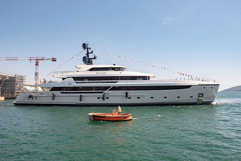 a large white ship with a red boat on the water aboard LEMON TREE Yacht for Charter