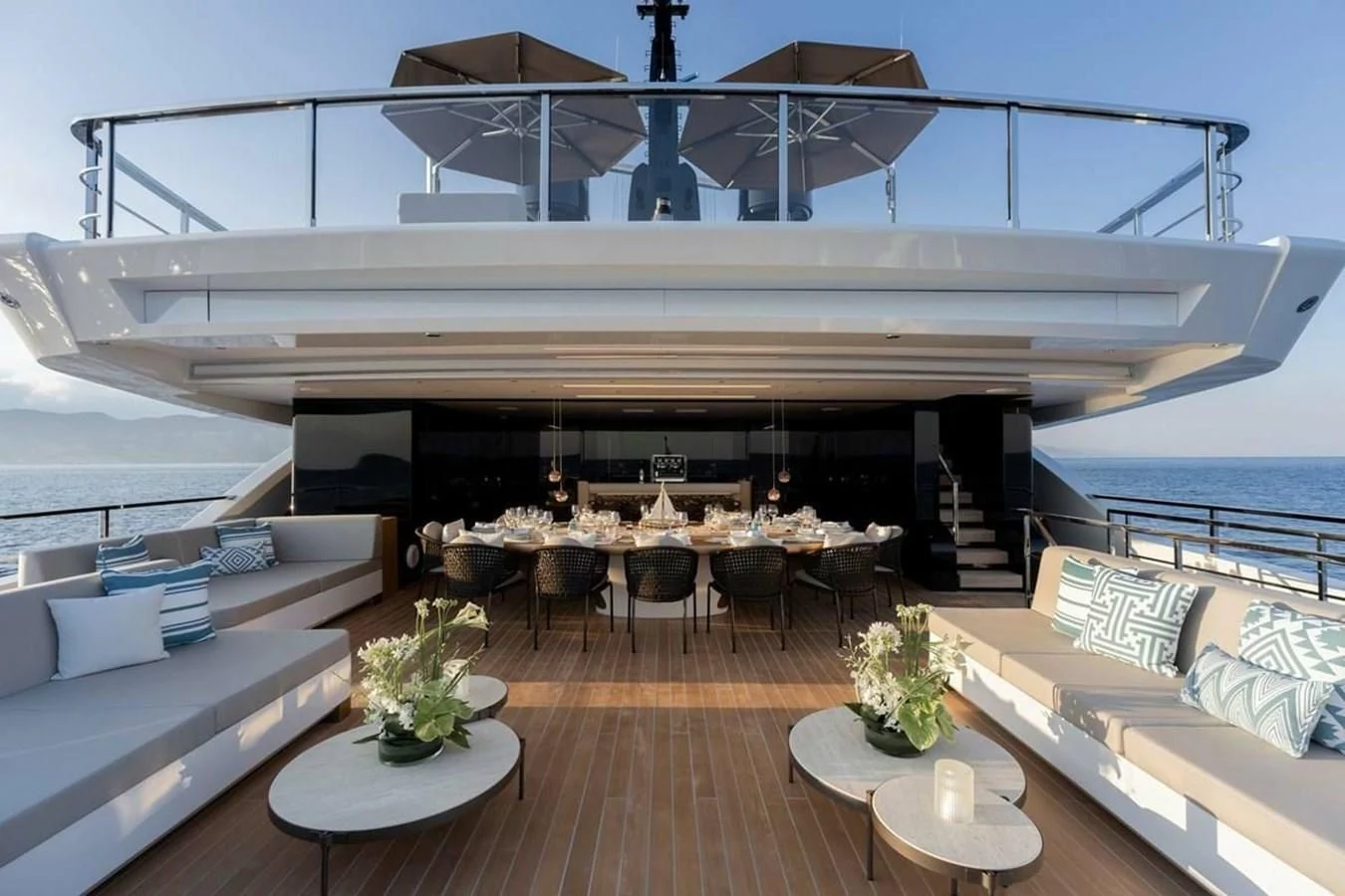 a room with a wood floor and a large white boat on the water aboard LEMON TREE Yacht for Charter