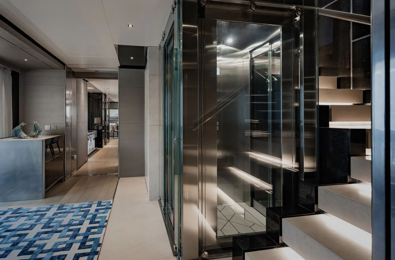 a room with glass walls and a staircase aboard LEMON TREE Yacht for Charter