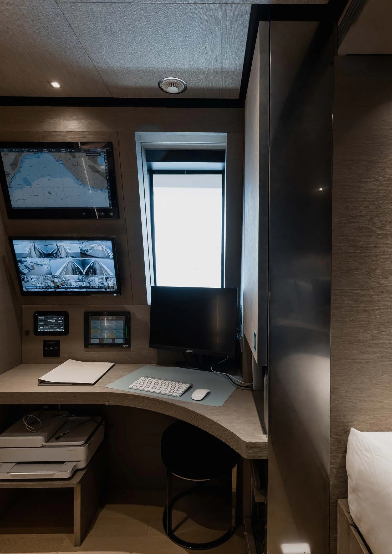 a computer desk with a monitor and a printer aboard LEMON TREE Yacht for Charter
