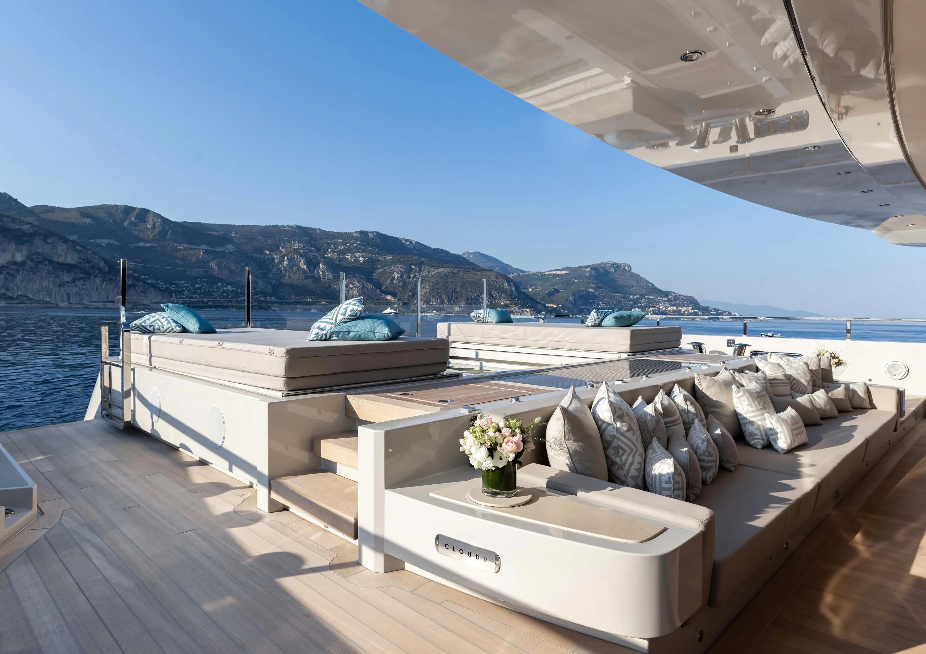 a deck with a view of a large ship and a large body of water aboard LEMON TREE Yacht for Charter