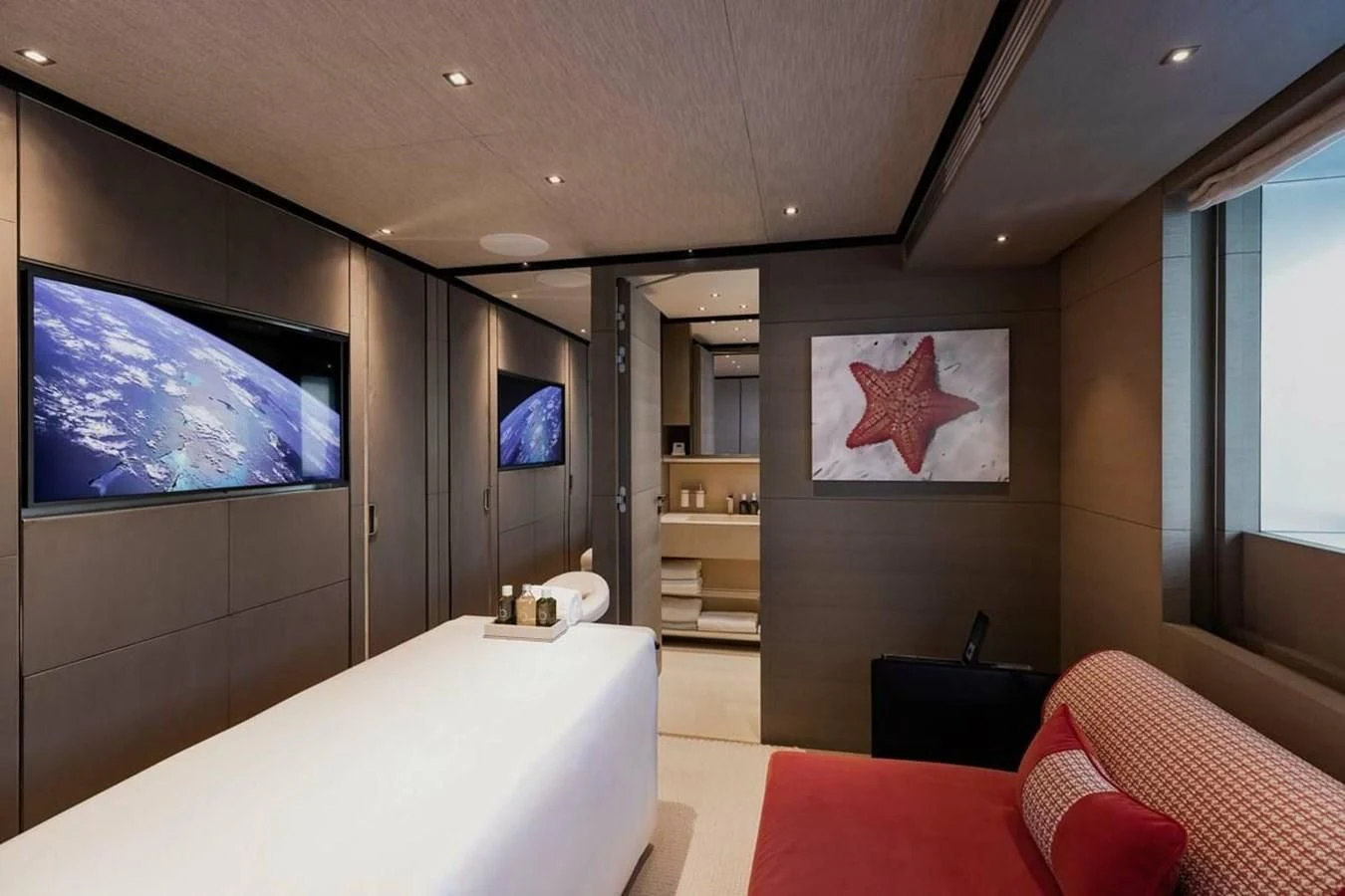 a room with a bed and a tv on the wall aboard LEMON TREE Yacht for Charter