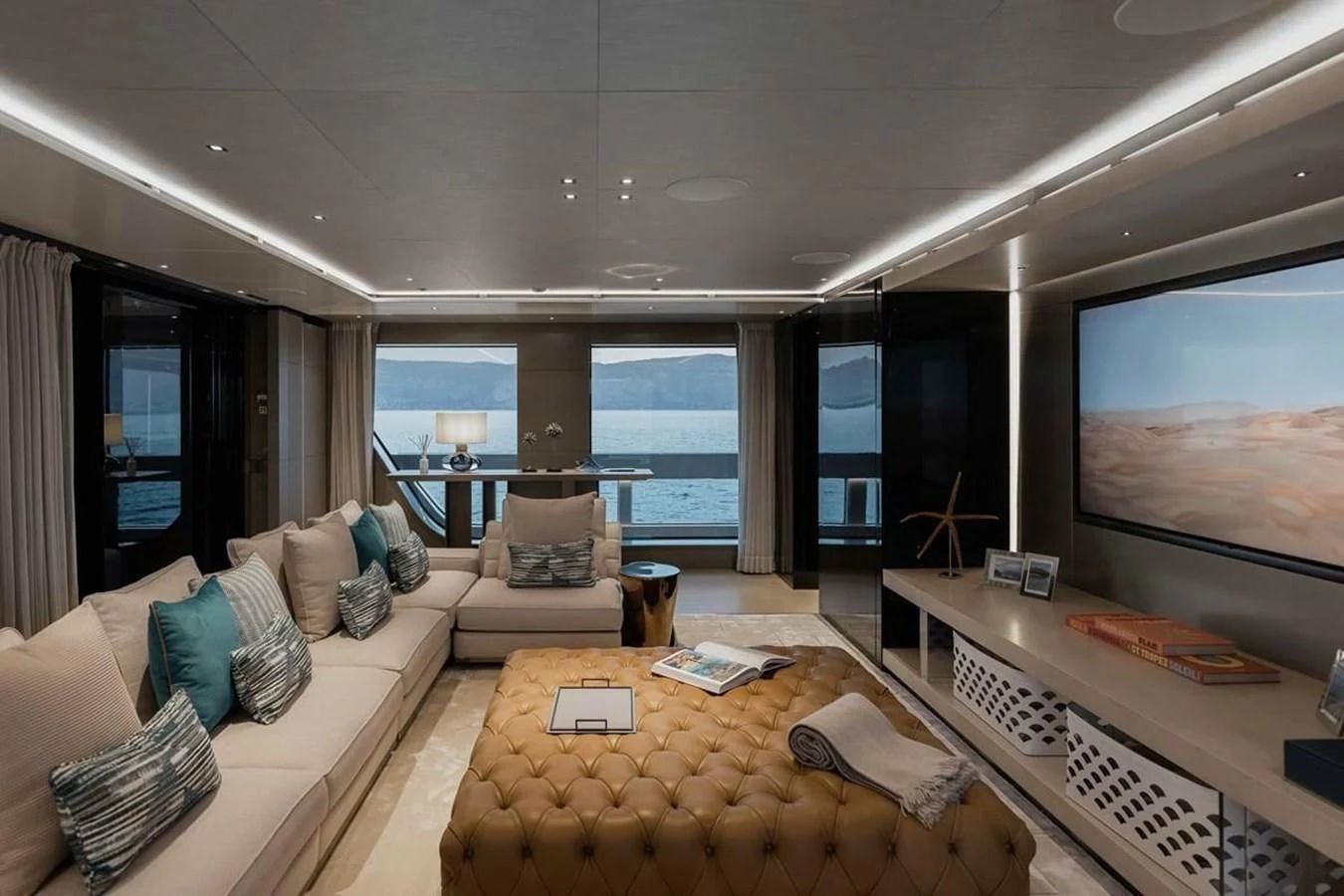 a living room with a large screen aboard LEMON TREE Yacht for Charter