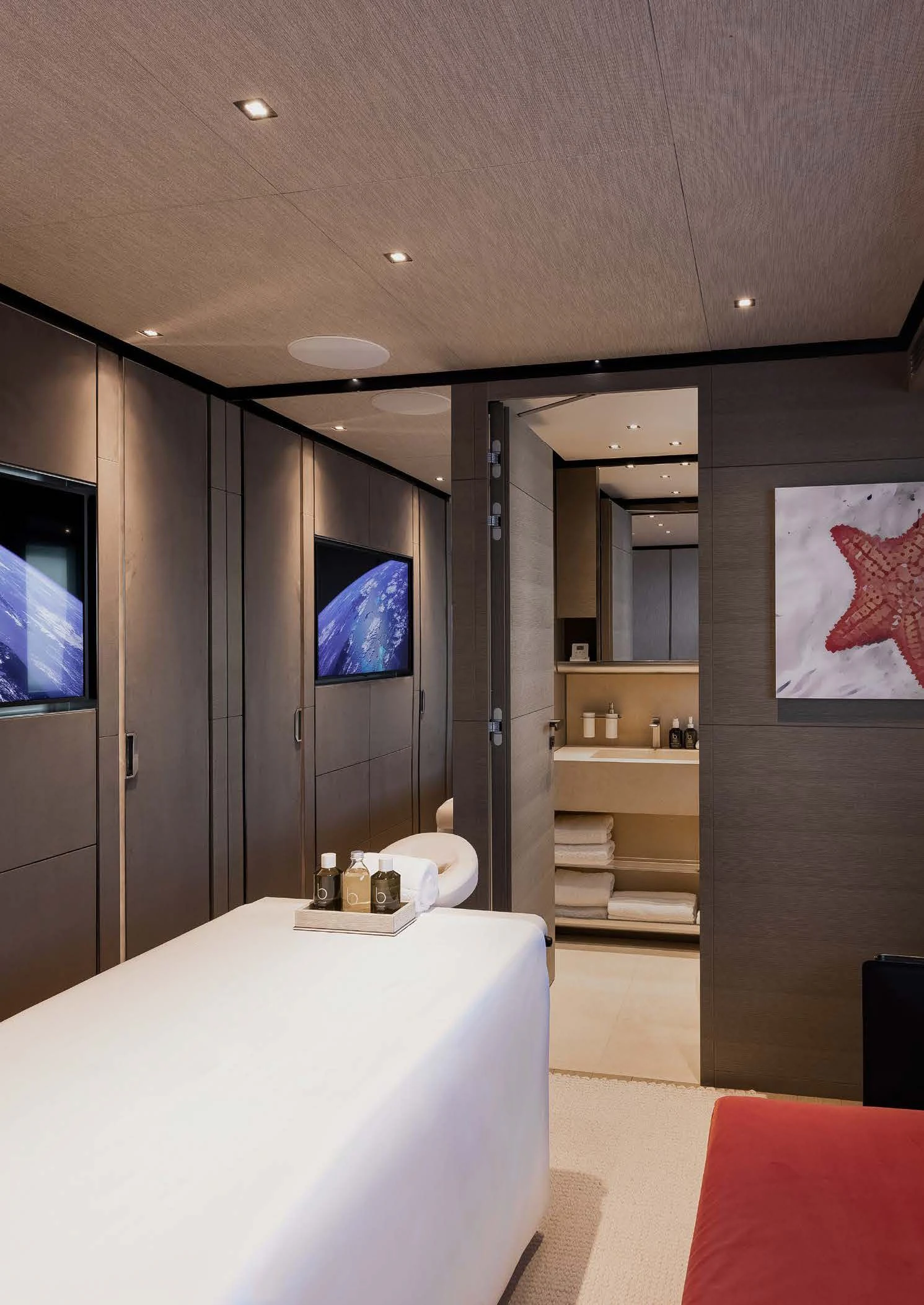 a room with a bed and a tv on the wall aboard LEMON TREE Yacht for Charter