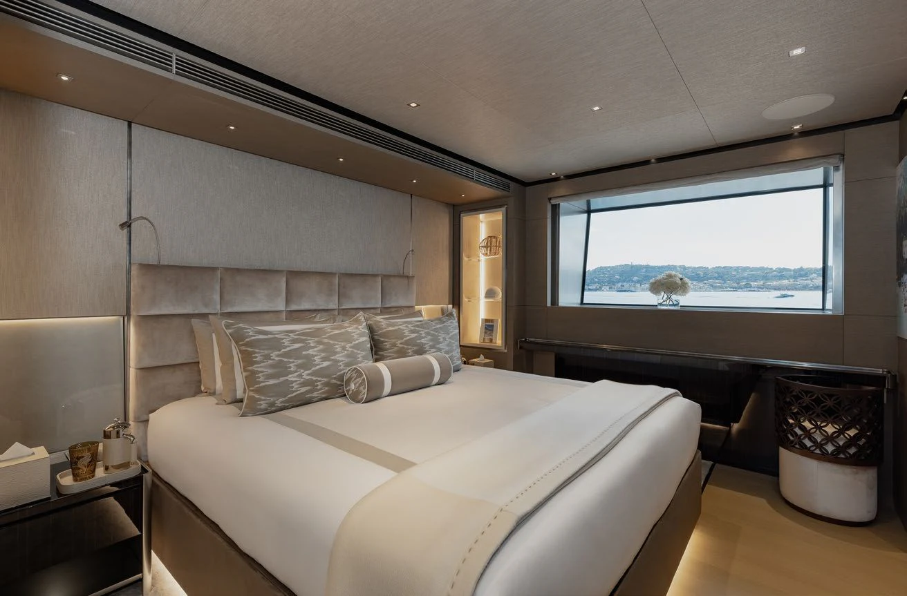 a bedroom with a bed and a window aboard LEMON TREE Yacht for Charter