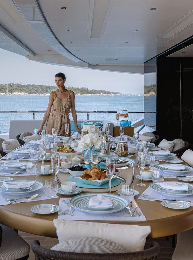 a table with plates and glasses on it aboard LEMON TREE Yacht for Charter