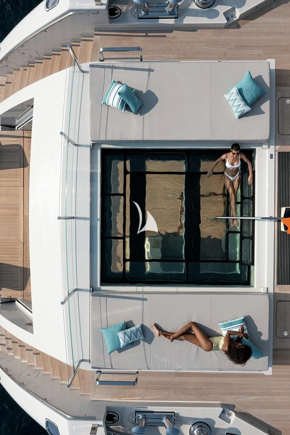 a group of people standing on a balcony aboard LEMON TREE Yacht for Charter