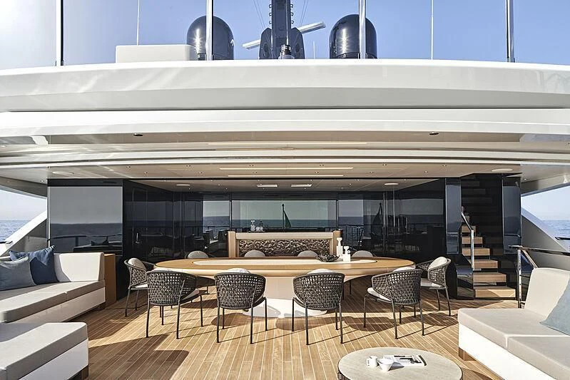 a room with a table chairs and a staircase aboard LEMON TREE Yacht for Charter