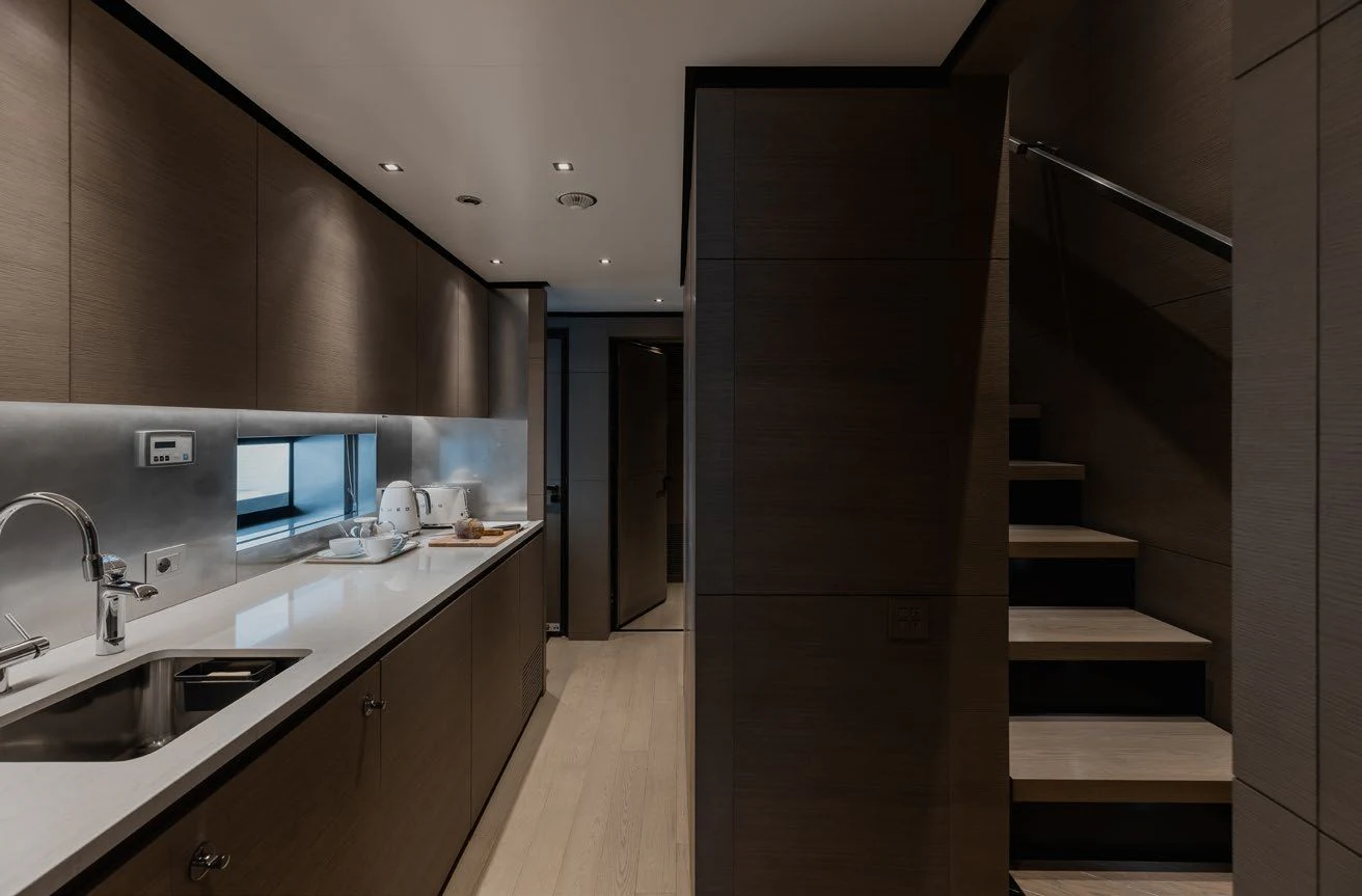 a kitchen with a sink and a staircase aboard LEMON TREE Yacht for Charter