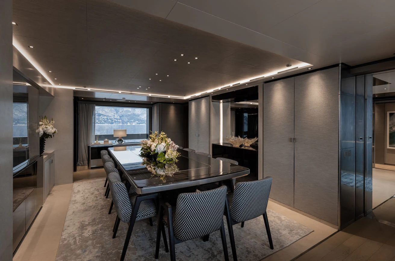 a large dining table in a room aboard LEMON TREE Yacht for Charter
