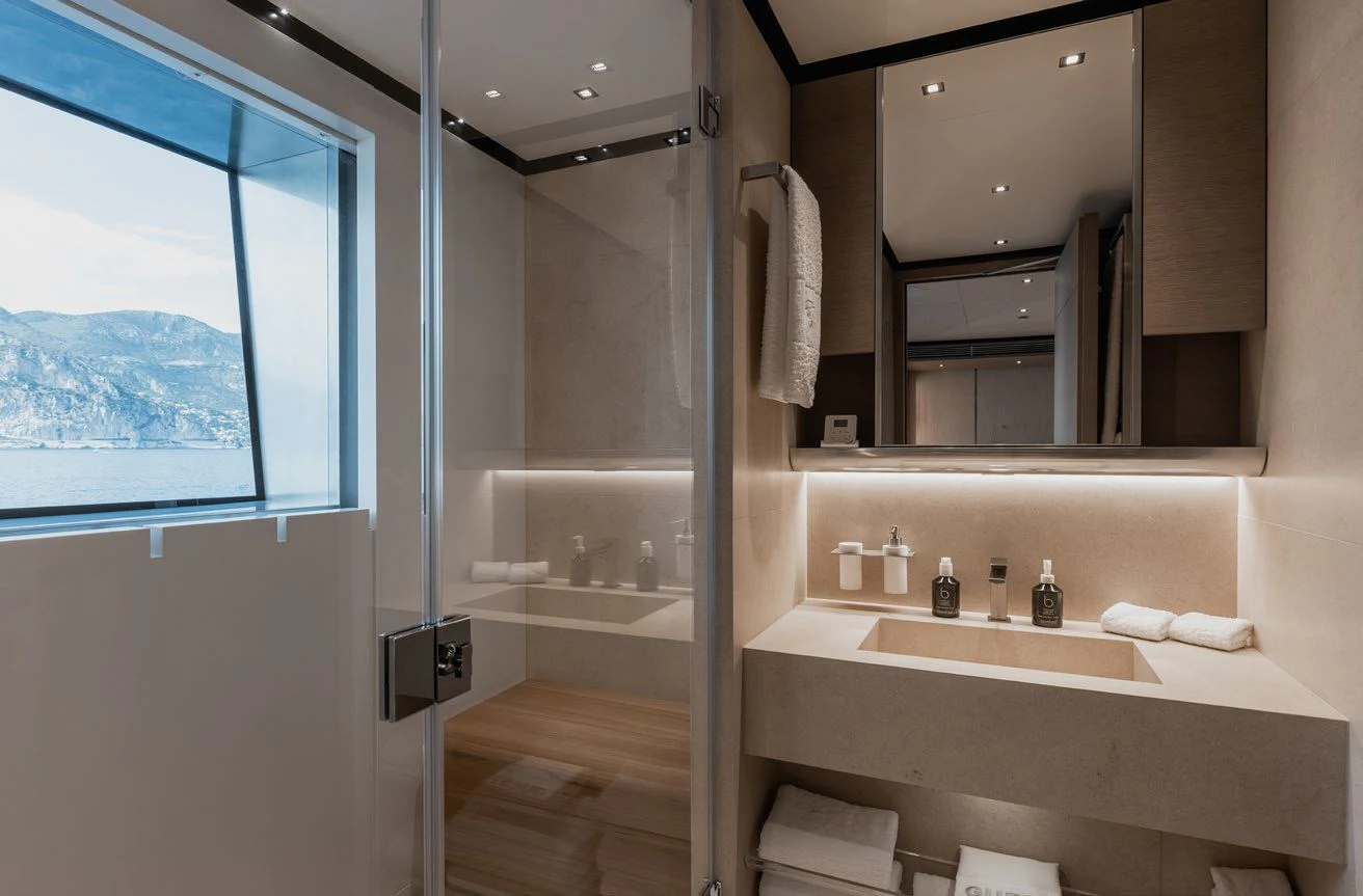 a bathroom with a large mirror aboard LEMON TREE Yacht for Charter