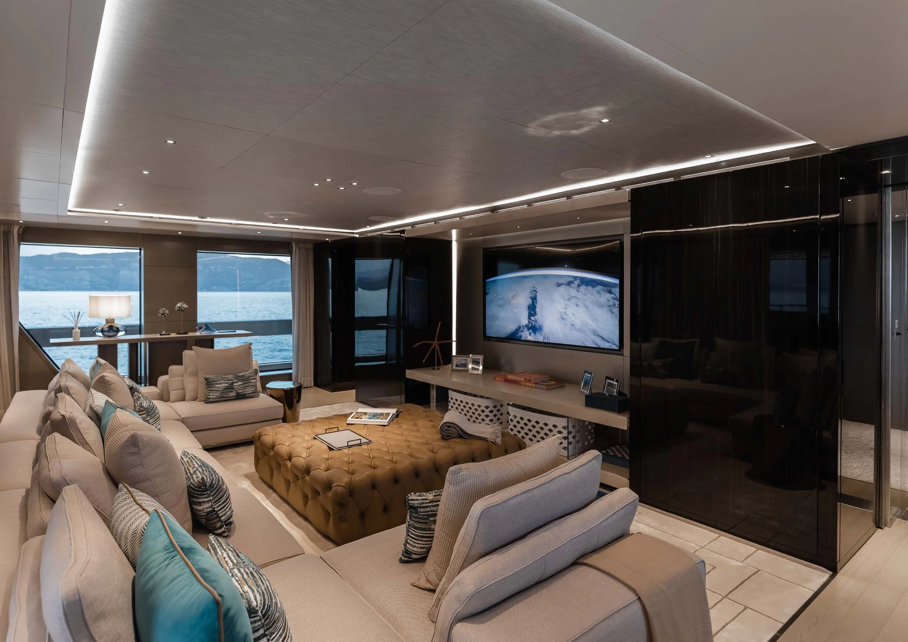 a living room with a large screen aboard LEMON TREE Yacht for Charter