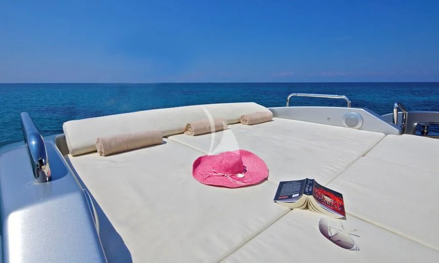 a white boat with red circles on it by the water aboard THEA MALTA Yacht for Sale
