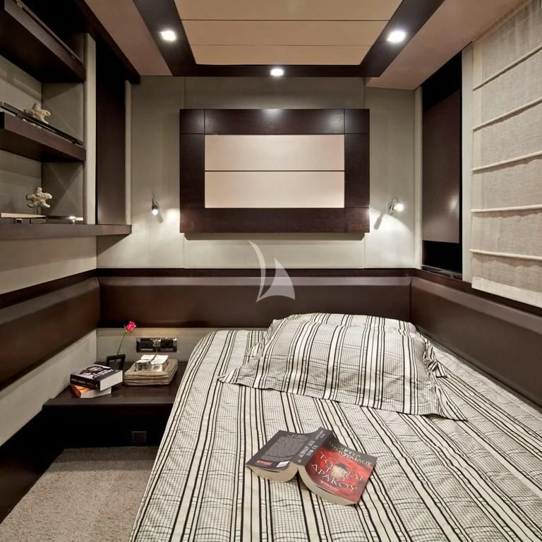 a room with a bed and a desk aboard THEA MALTA Yacht for Sale