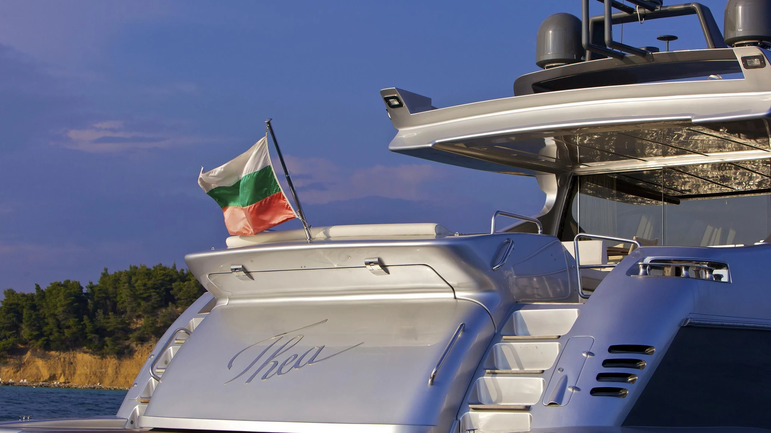 a boat with a flag on the front aboard THEA MALTA Yacht for Sale