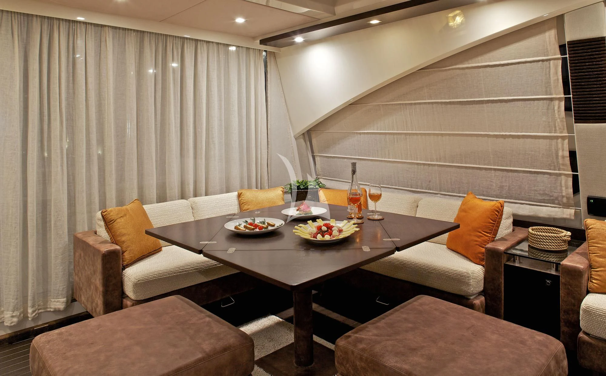 a room with a table and couch aboard THEA MALTA Yacht for Sale