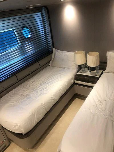 a bed with a window aboard KALA Yacht for Sale