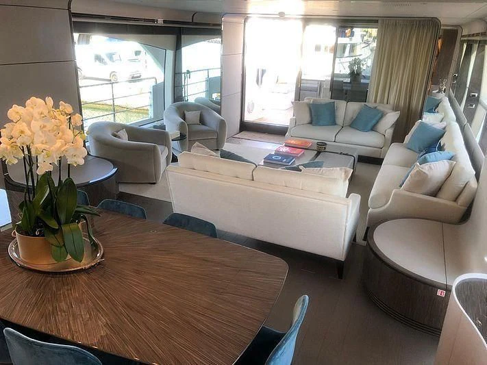 a living room with a table and couches aboard KALA Yacht for Sale