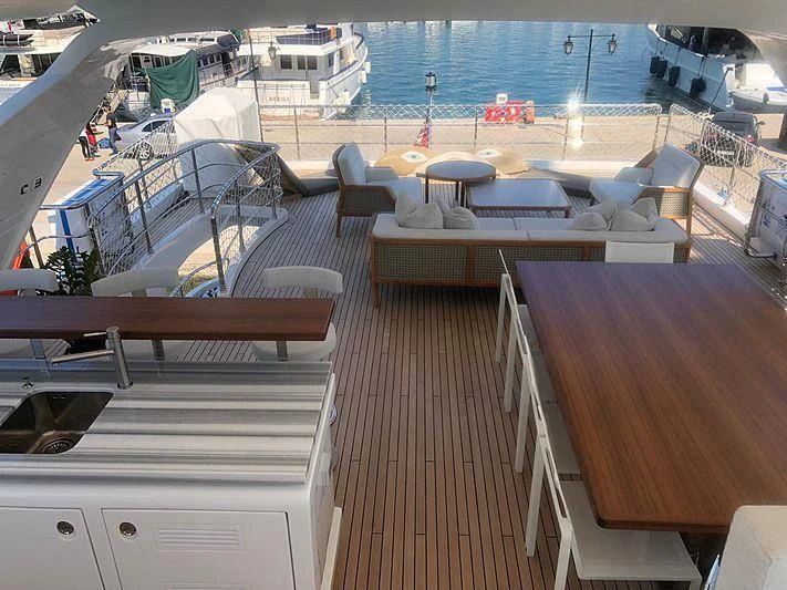 a deck with a deck and chairs aboard KALA Yacht for Sale