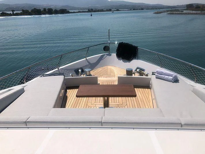 a cat sitting on a deck aboard KALA Yacht for Sale