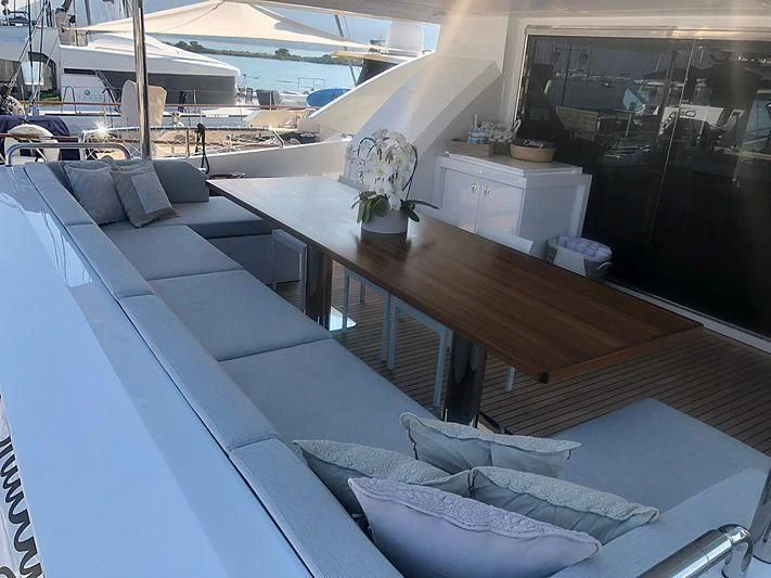 a deck with a pool table and chairs aboard KALA Yacht for Sale