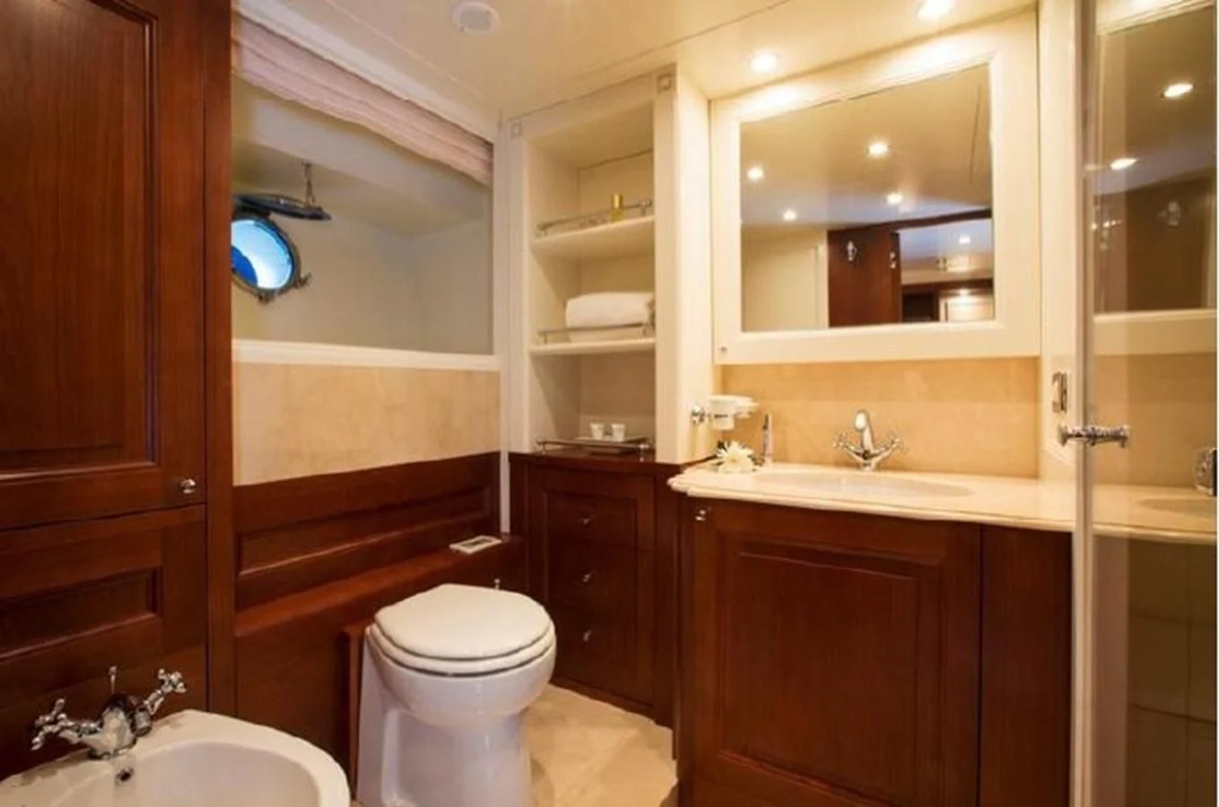 a bathroom with a toilet sink and a mirror aboard M.C. Yacht for Sale