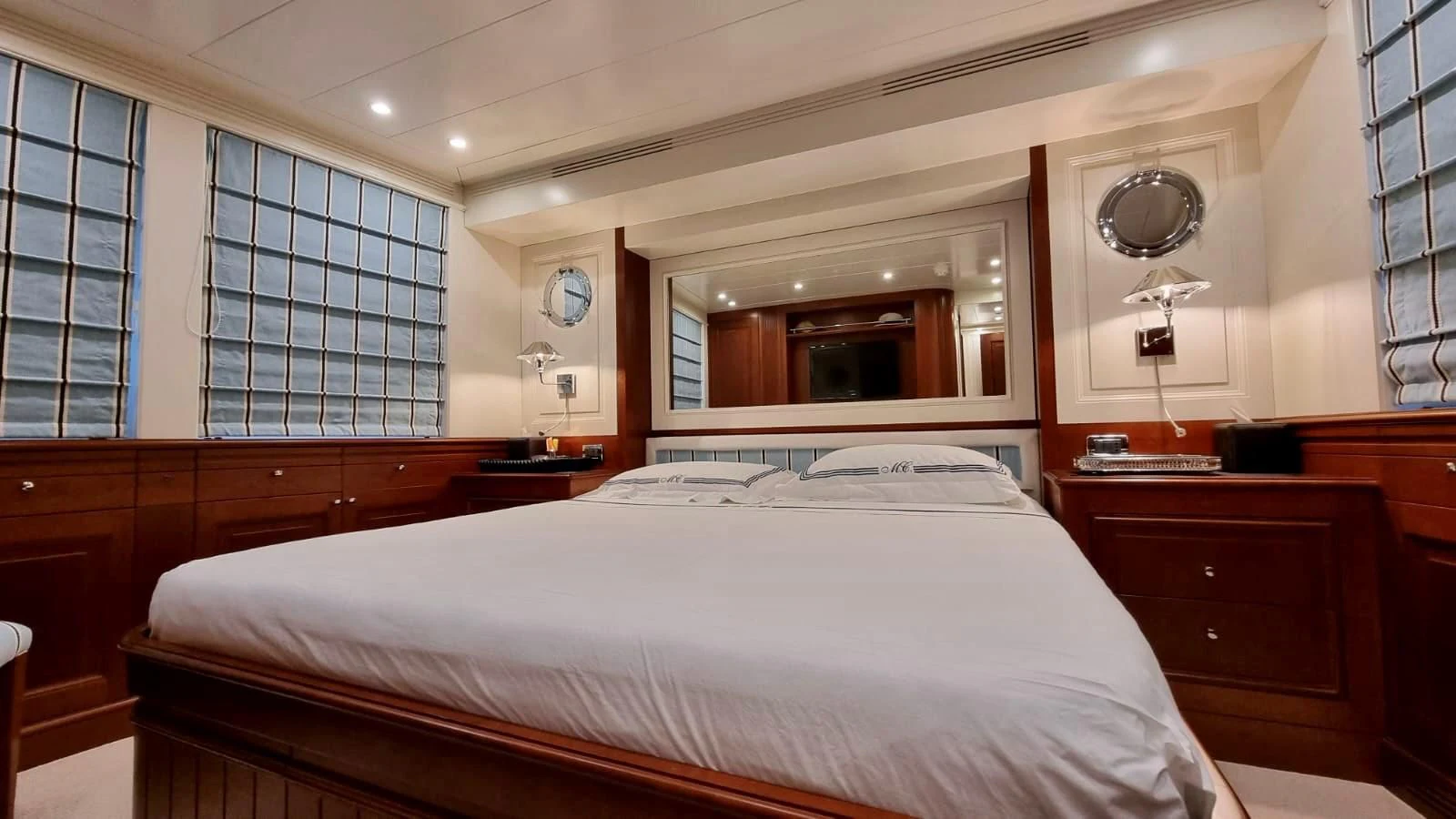 a room with a bed and a mirror aboard M.C. Yacht for Sale