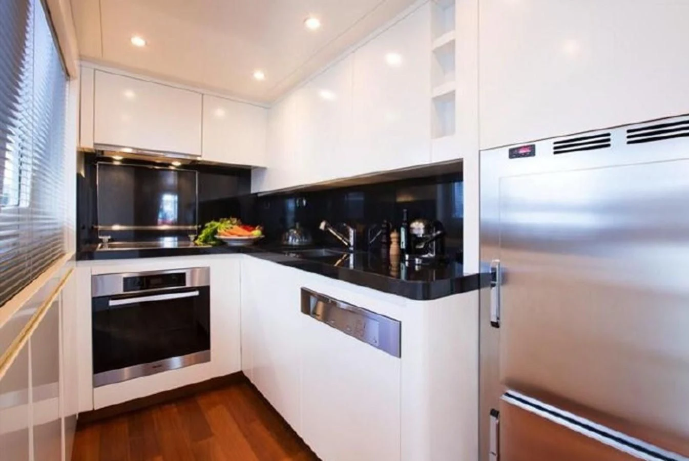 a kitchen with white cabinets aboard M.C. Yacht for Sale