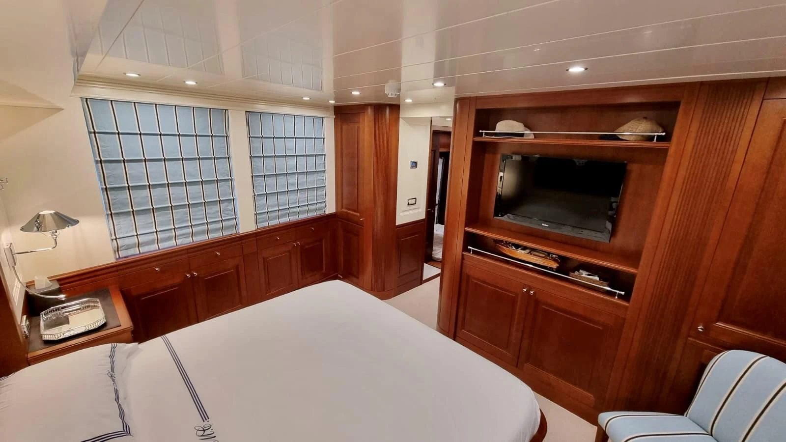 a room with a bed and a television aboard M.C. Yacht for Sale