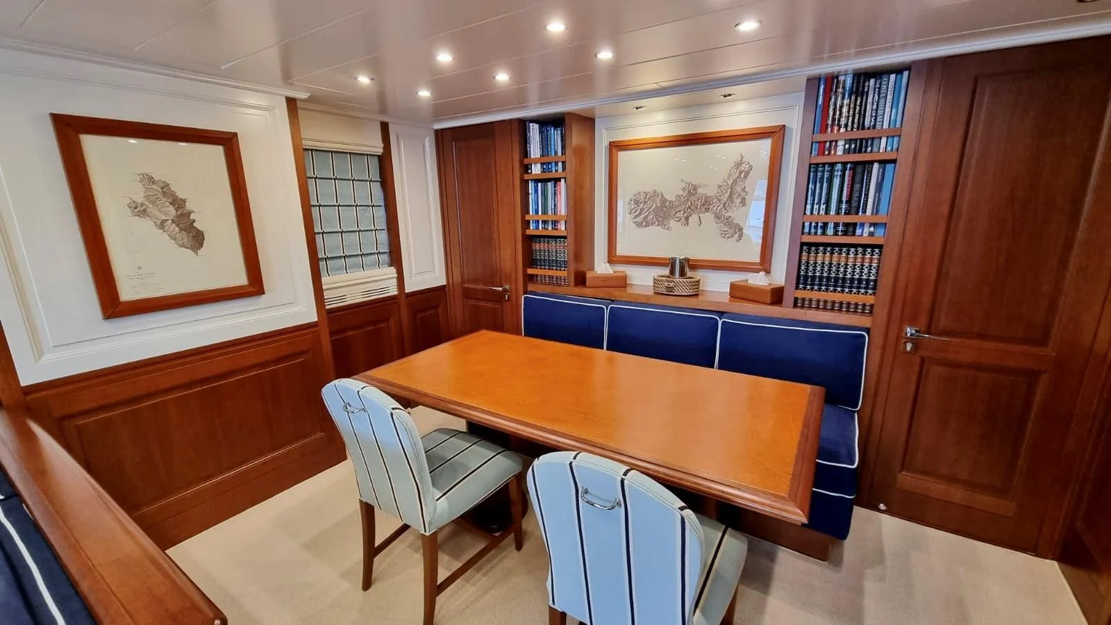 a room with a table and chairs aboard M.C. Yacht for Sale