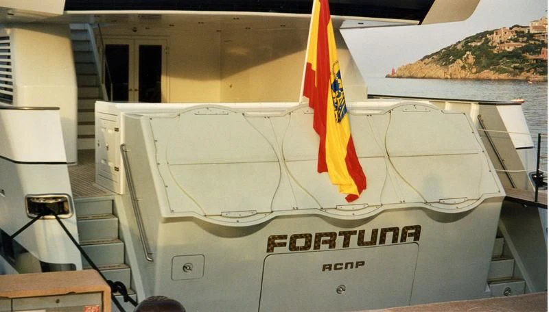 a boat with a flag on the front aboard FONERS Yacht for Sale