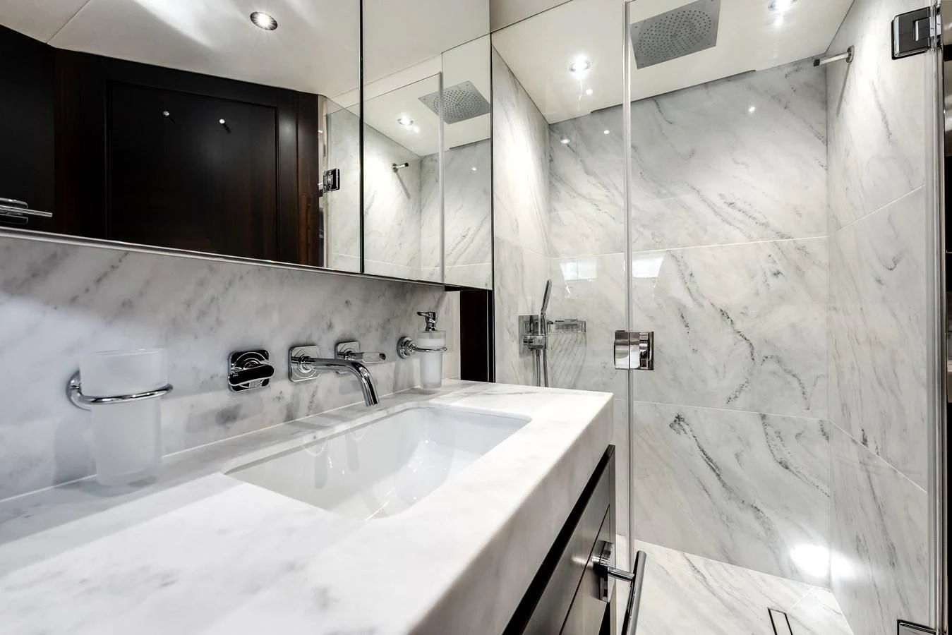 a bathroom with a large mirror aboard TRIGGER HAPPY Yacht for Sale