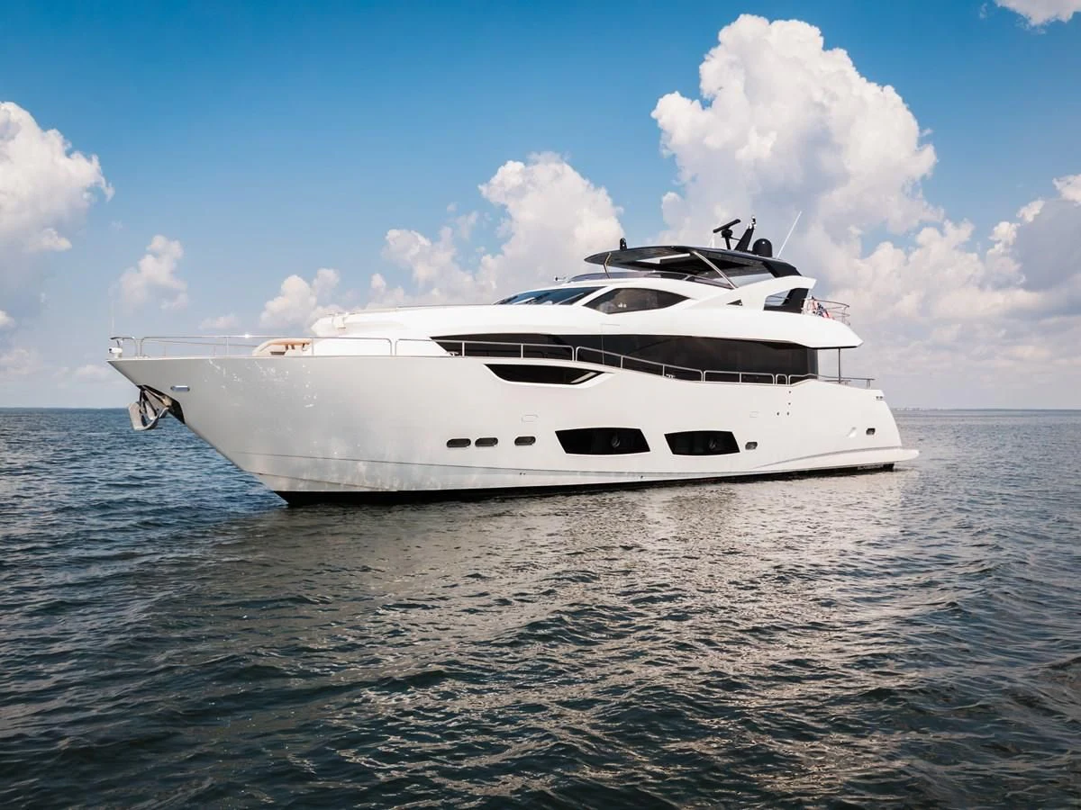 a white yacht in the water aboard TRIGGER HAPPY Yacht for Sale