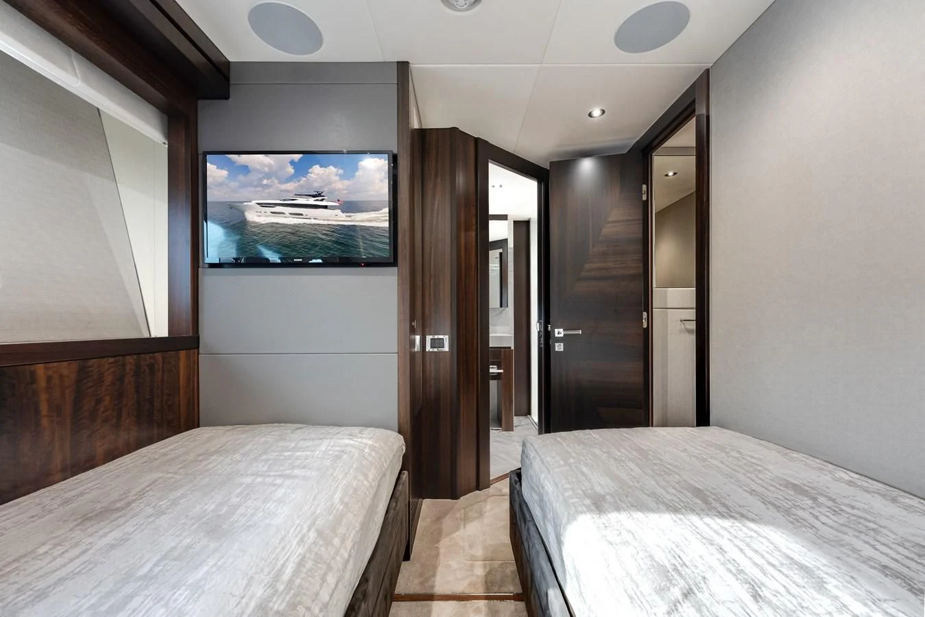 a room with a bed and a television aboard TRIGGER HAPPY Yacht for Sale