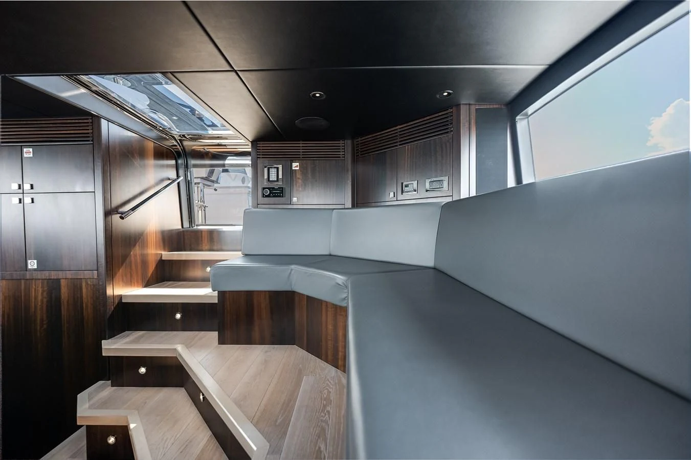 a room with a large window and a table with chairs aboard TRIGGER HAPPY Yacht for Sale