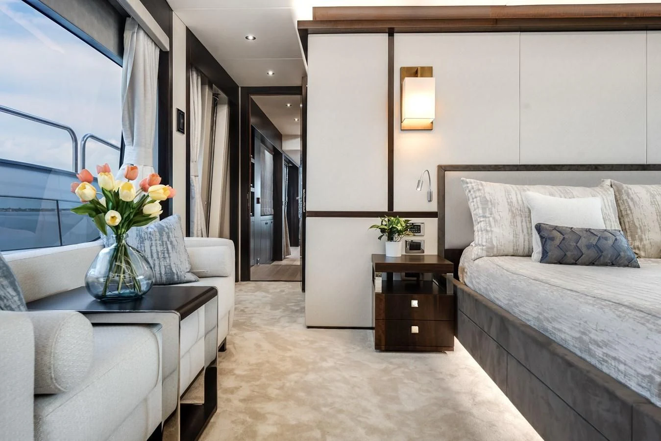 a room with a bed and a table aboard TRIGGER HAPPY Yacht for Sale