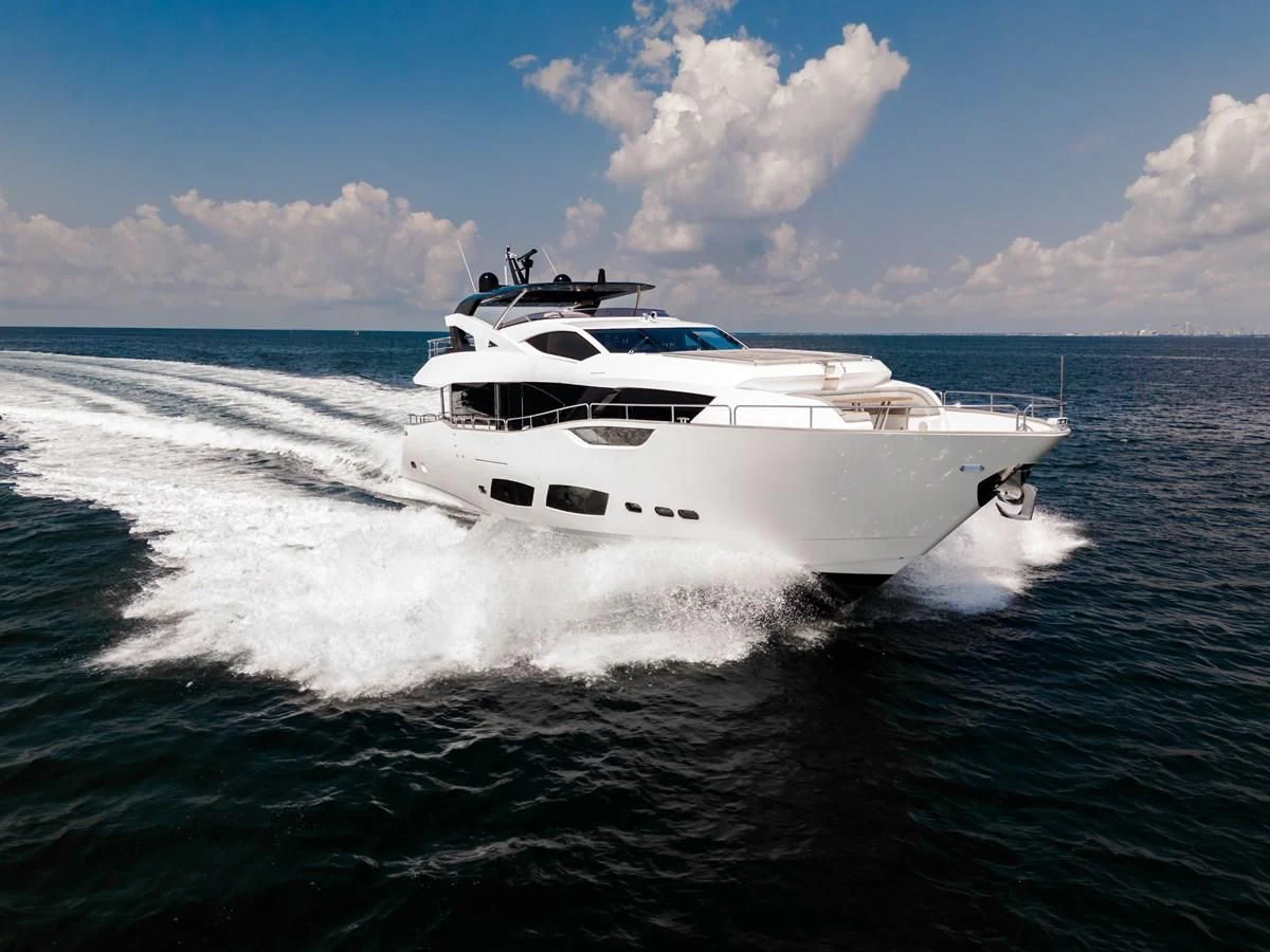 a white yacht on the water aboard TRIGGER HAPPY Yacht for Sale